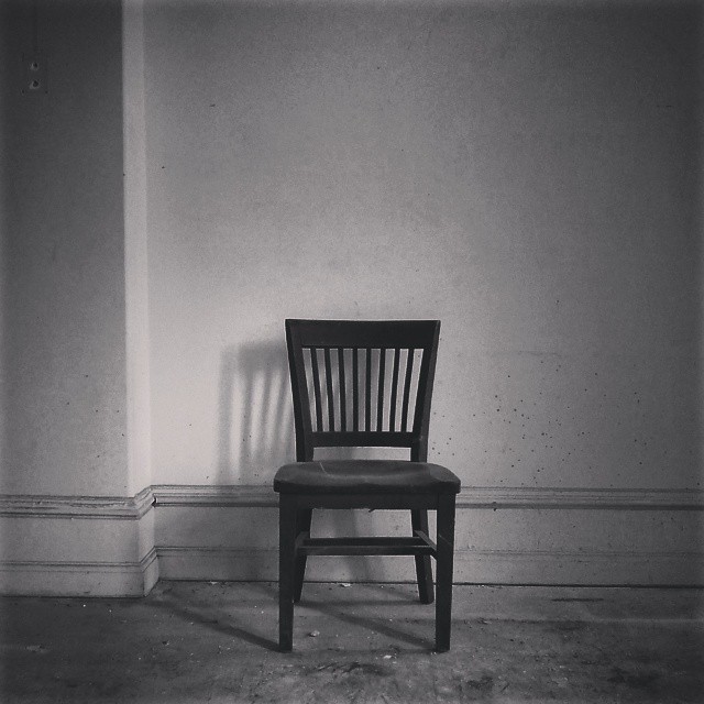 Empty chair in a misty room